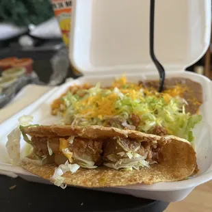 This meat mixture has potatoes carrots and possible hamburger meat.