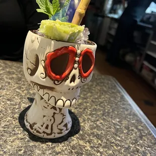 a skull cup with a drink in it