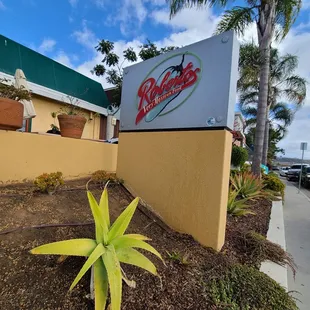 a sign in front of a restaurant