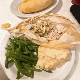 Fish en Papillote- catch of the day with herbs and lemon in the traditional French style, topped with jumbo lump crab meat