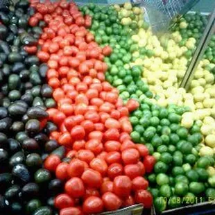 a display of tomatoes and avocados