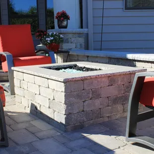 a patio with a fire pit