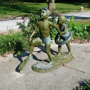 untitled sculpture of kids going swimming by Davidson near the aquatic center