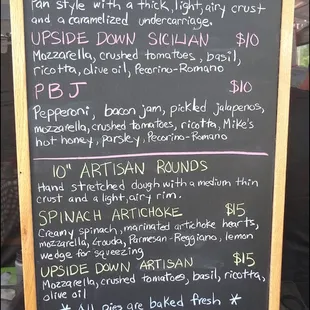 The menu at Robert's Pizza Oven features "Sicilian Squares" and "Artisan Rounds," all made on site.