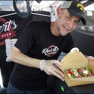 Meet super-friendly Mr. Robert Romanowski, the owner and talented pizza chef at Robert's Pizza Oven, as he presents my "PBJ" with a smile.