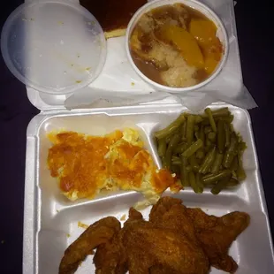 Fried chicken wings, green beans, mac and cheese, cornbread, and peach cobbler.