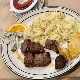 a plate of meat and rice