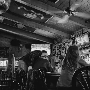 a black and white photo of a bar