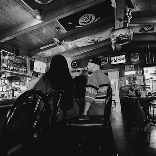 a black and white photo of a bar