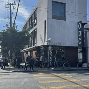 people waiting at the corner of the street
