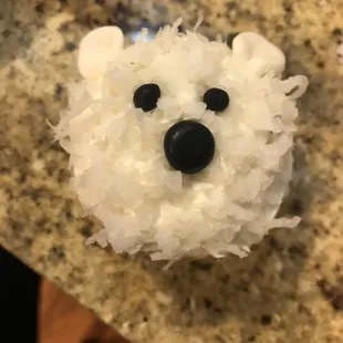 Polar Bear Cupcake - Vanilla Buttercream dipped in Sweetened Shredded Coconut and topped with fondant facial features