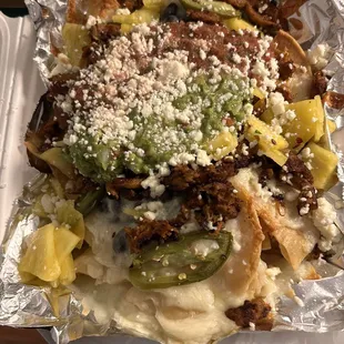 (Soy curl) Al pastor nachos to go without sour cream because I HATE sour cream