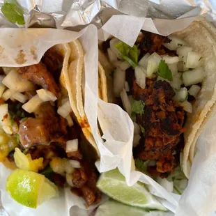 Soy pastor taco (left) and veggie sausage taco (right); both vegan