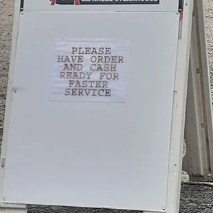 a sign in front of a parking lot