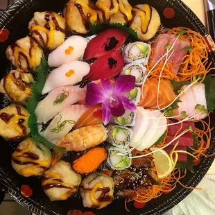 a bowl of sushi with a variety of toppings