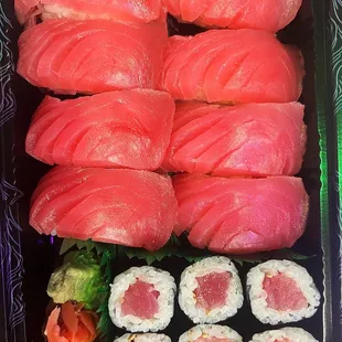 a tray of sushi and rolls
