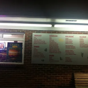 a menu on a brick wall