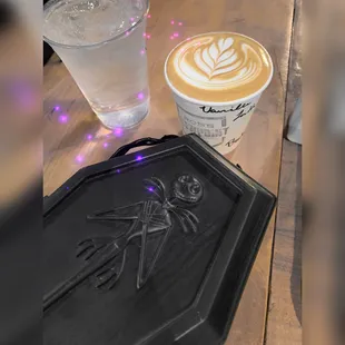 a cup of coffee with a spider on it