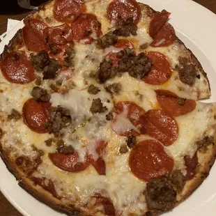 Cauliflower crust pizza with pepperoni and sausage