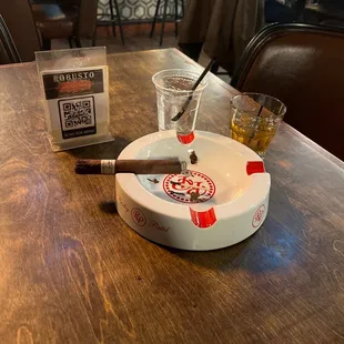 a cigar and a cigar tray