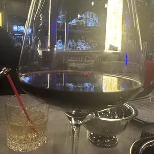 Red wine and a green tea drink in the background