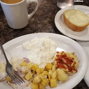 Cottage cheese, croutons, pasta salad and bread.