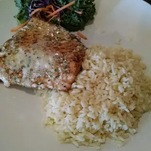 Grilled salmon with garlic butter sauce and rice.
