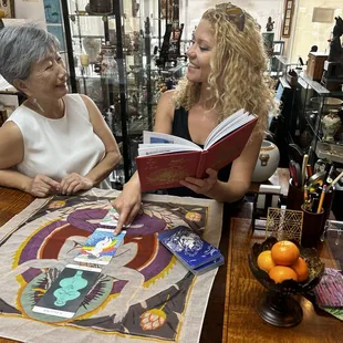 Judy Buntin and gallery assistant Mikela enjoying a new work of art by friend and magnificent artist, Mayumi Oda.