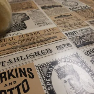 Table tops with NYC newspaper ads from the yore. Cool