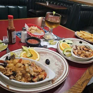 Seafood platter with beans and baked potato.  Shrimp, octopus and chile platter over garlic sauce with beans and fried