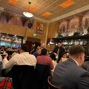 people sitting at tables in a restaurant