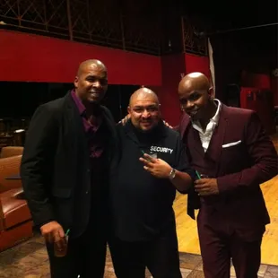 three men in suits posing for a picture