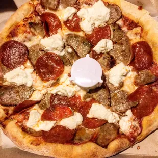 Mini pizza with pepperoni, sausage, and ricotta.