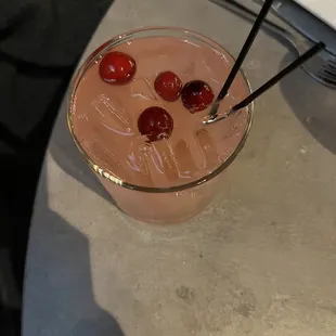 a drink with cherries in it