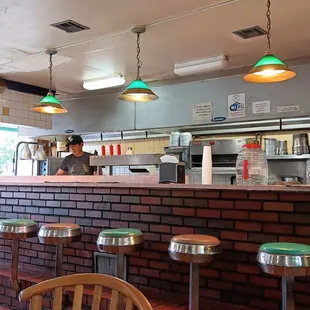 a brick counter and stools