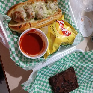 Meatball sub with marinara sauce and brownie foe dessert. Absolutely Delicious