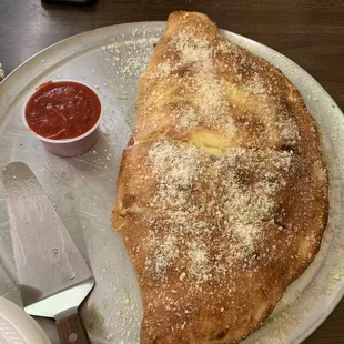 a plate of pizza with a slice taken out of it