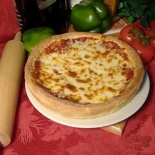 a pizza on a plate with a rolling pin