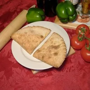 two slices of pizza on a plate with a rolling pin