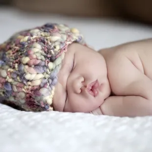 Lifestyle family session, newborn baby girl snuggled in.