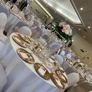 Flatware, plates, napkins, centerpieces, table runner, tablecloth, tables, chairs, chair covers