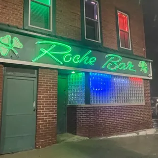 a neon sign on the side of a building