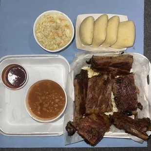 Rack Pack... Rack of Ribs, BBQ Sauce on the side, 2 Large Size Dinner Sides (Baked Beans &amp; Coleslaw "Vinegar" base), 4 Dinner Rolls.