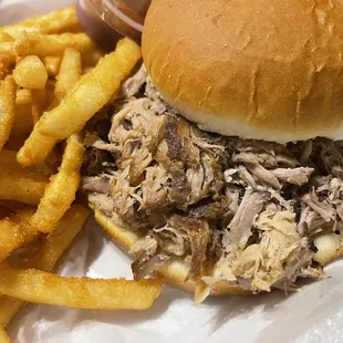 Pulled pork sandwich with crispy fries. Slightly spicy barbecue sauce, very tasty.