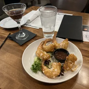 Espresso martini and coconut shrimp appetizer.