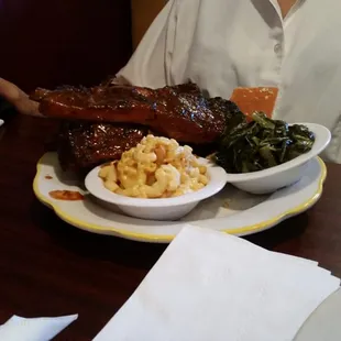 Six pork ribs platter with macaroni and cheese, collar greens and cornbread.