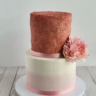 a three tiered cake with pink flowers