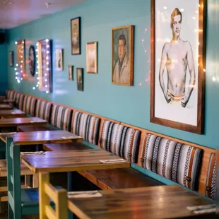 a row of wooden tables and benches in a restaurant