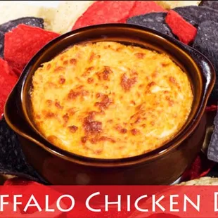 Buffalo Chicken Dip: avory tender chicken paired with ranch and buffalo sauce, baked, and served with white corn tortilla chips.