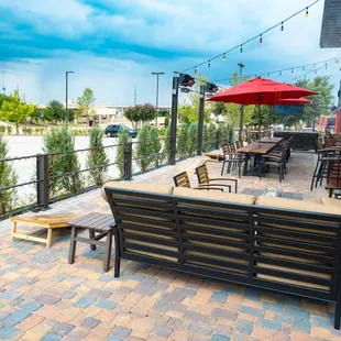 Uncovered patio with lounge style couches, table top seating, and games